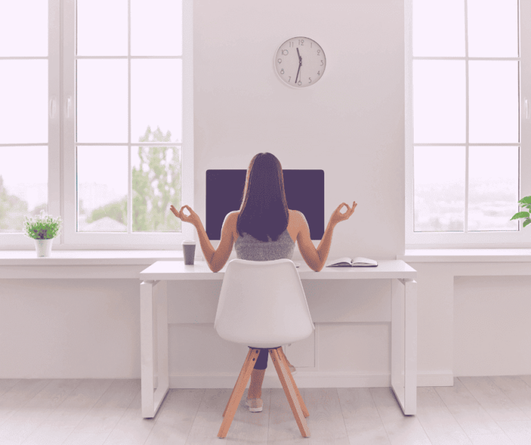 a woman sitting at a desk with her hands in front of a computer